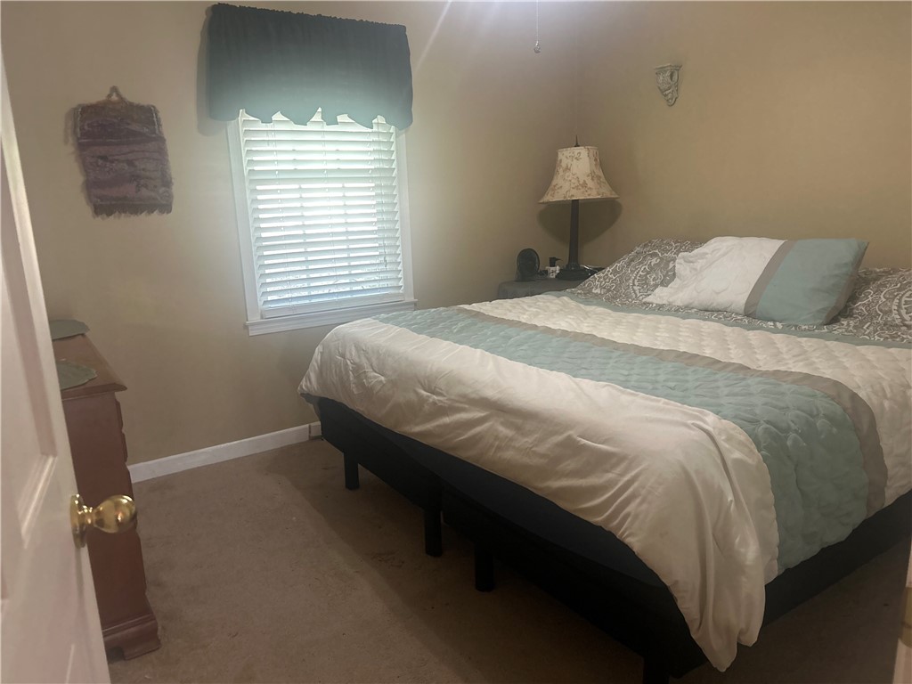 418 Saluda Road Williamston, SC 29697 - Photo 35 of 40 Comfortable bedroom with soft carpet and natural light from a window with blinds.
