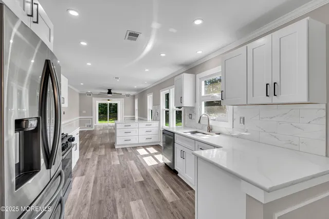 a kitchen with a sink window and cabinets
