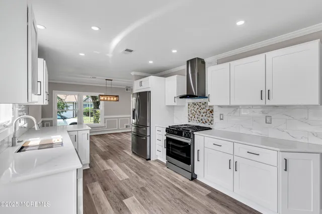 a large white kitchen with a table and chairs in it