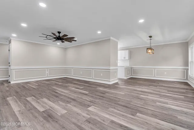 a view of an empty room and wooden floor