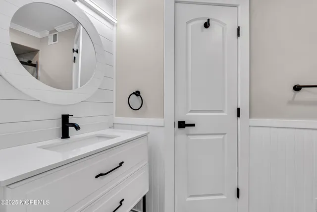 an empty room with wooden floor and ceiling fan