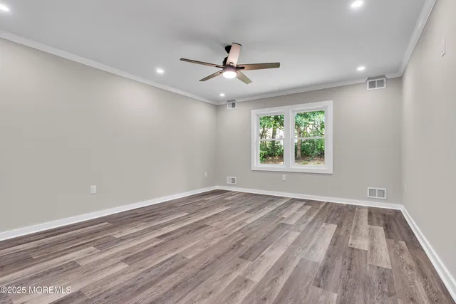 a front view of a house with a garden and trees