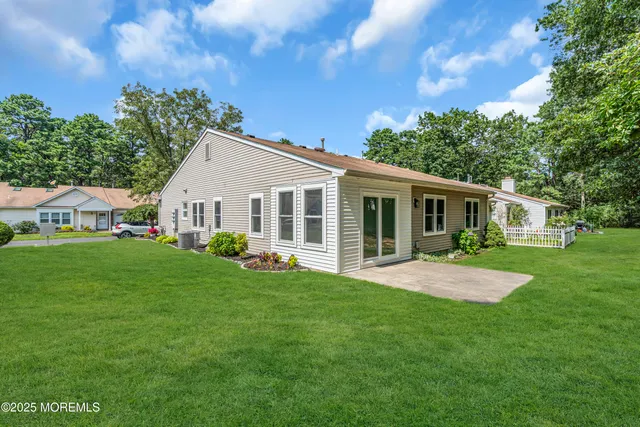 a view of a house with backyard and porch