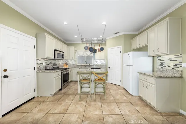 a kitchen with stainless steel appliances granite countertop a sink and cabinets