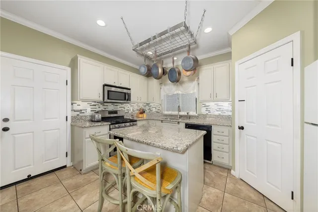 a kitchen with stainless steel appliances granite countertop a sink stove microwave and cabinets