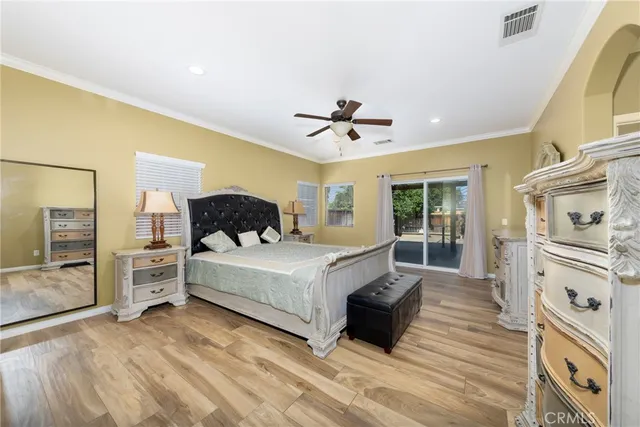 a spacious bedroom with a bed a couch and dresser