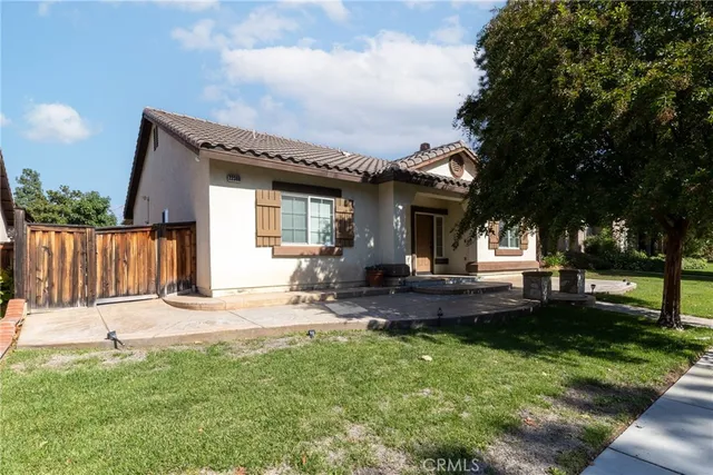 a front view of a house with garden and patio