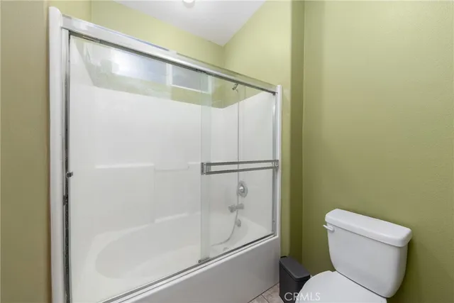 a bathroom with a granite countertop sink a mirror a bathtub and shower