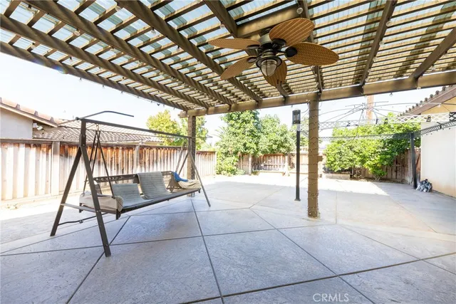 a view of an empty room with wooden floor and windows