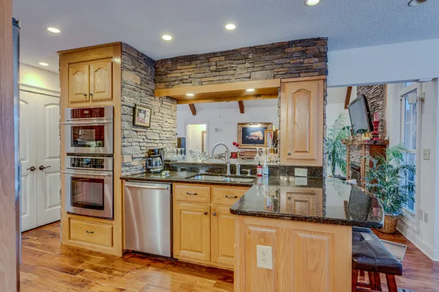 a dining room with furniture potted plants and wooden floor