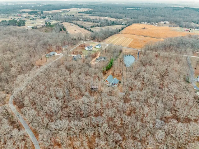 a view of swimming pool with a yard and trees