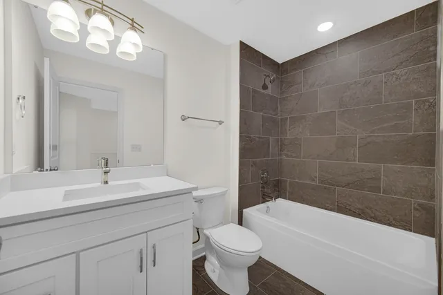 a bathroom with a sink a toilet and bathtub