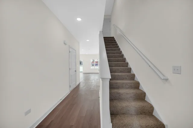 a view of entryway and hall with wooden floor