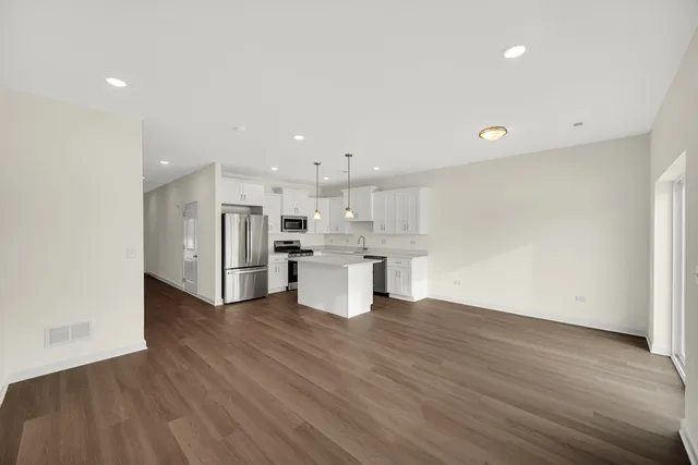 a view of kitchen with wooden floor and windows