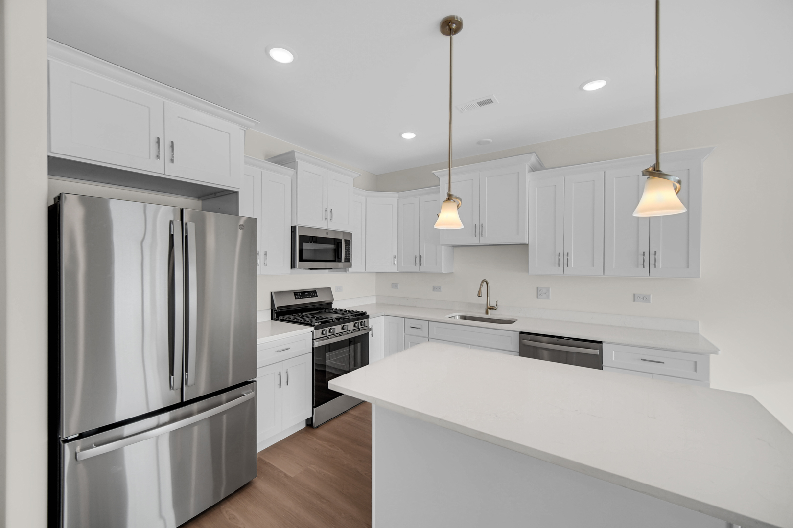 5404 135th Street Crestwood, IL 60418 - Photo 9 of 23 a large kitchen with stainless steel appliances a refrigerator a stove a sink and a center island