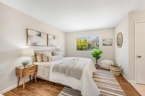 a bedroom with a bed and wooden floor