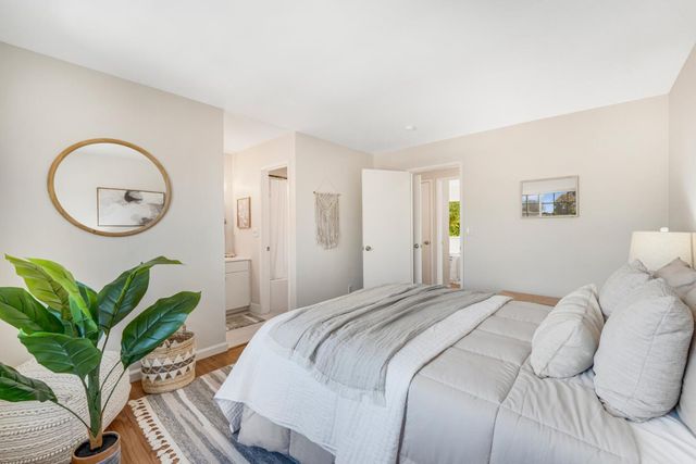 a bedroom with bed and a potted plant