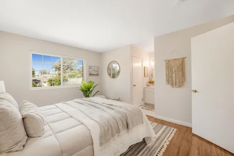 a bedroom with a large bed and a window