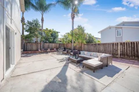 a view of a patio with couches and a fire pit