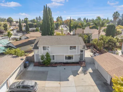 a view of a house with a yard and sitting area