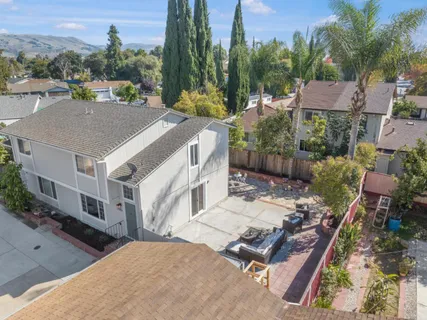 a aerial view of a house with a yard patio and furniture