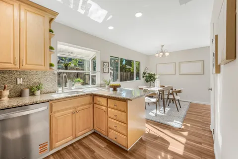 a kitchen with center island table and chairs