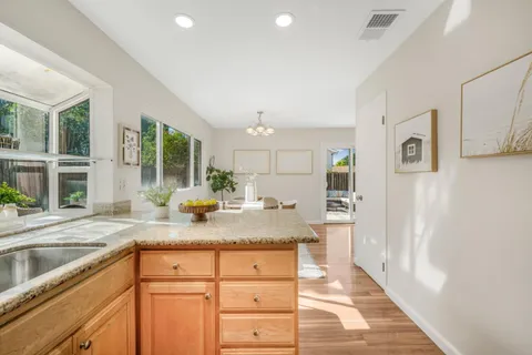 a kitchen with granite countertop cabinets stainless steel appliances and a counter space