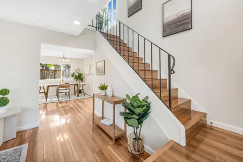 a view of entryway and hall with wooden floor