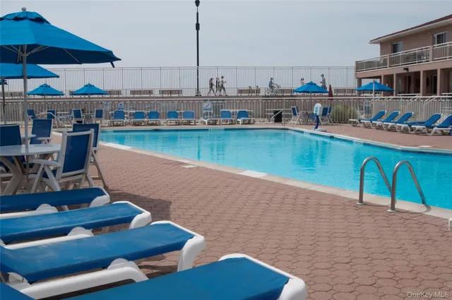 a view of a lake with a table and chairs