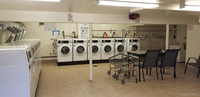 a utility room with multiple dryer and washer