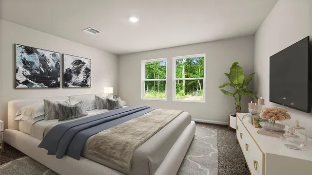 a bedroom with bed and a flat screen tv