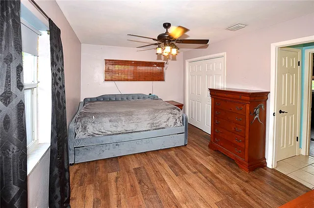a bedroom with a bed and a chandelier