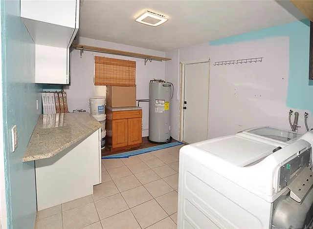 a kitchen that has a sink and a stove in it