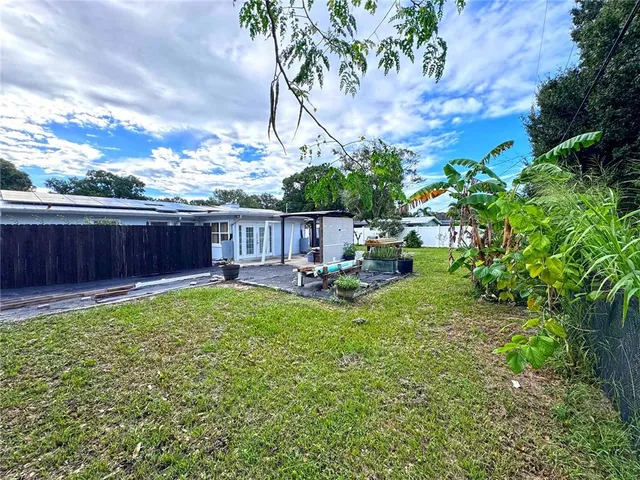 a view of a backyard with sitting area