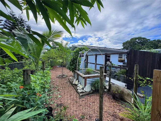 a backyard of a house with table and chairs