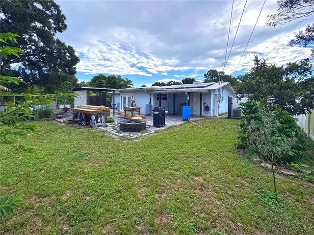 a view of a house with backyard and porch