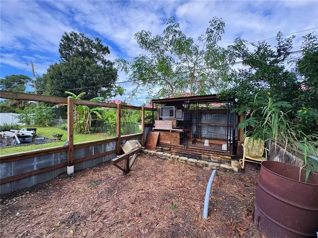 a view of a house with a yard and furniture