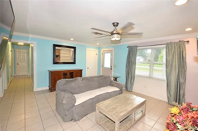 a living room with a couch and a chandelier