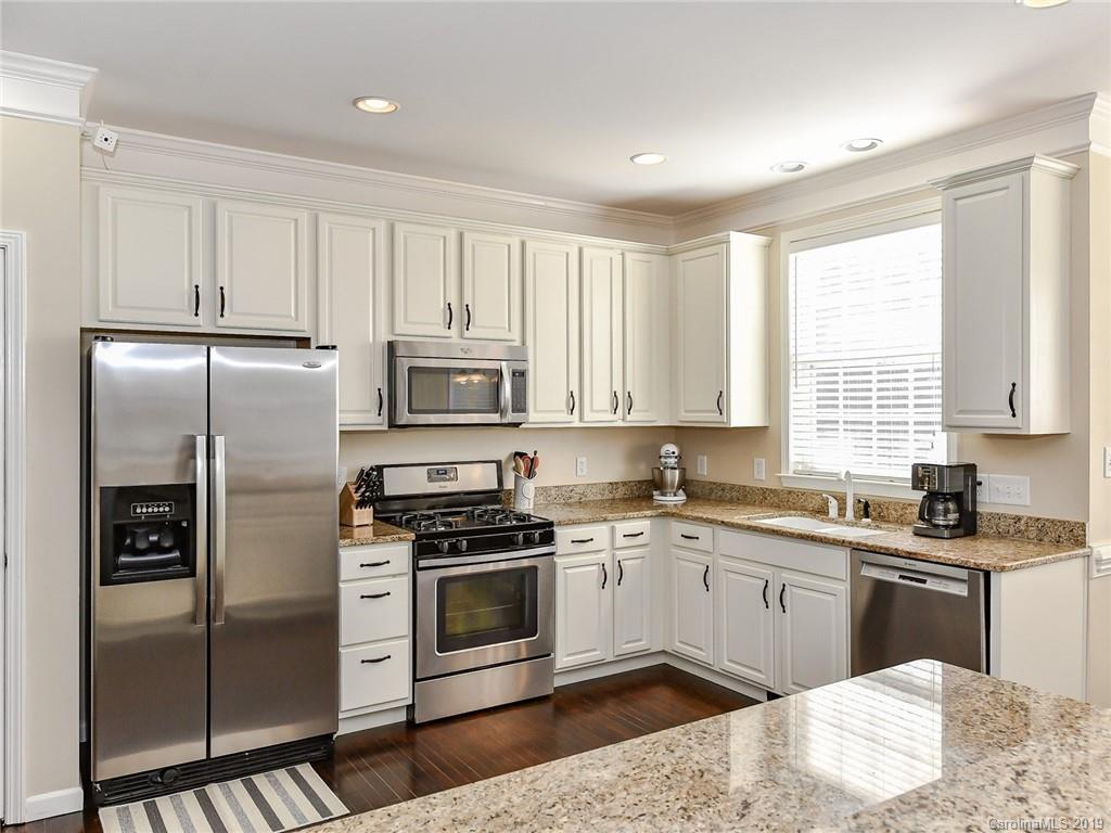 4723 Lapis Court Fort Mill, SC 29708 - Photo 12 of 36 a kitchen with stainless steel appliances granite countertop a stove a sink and a refrigerator