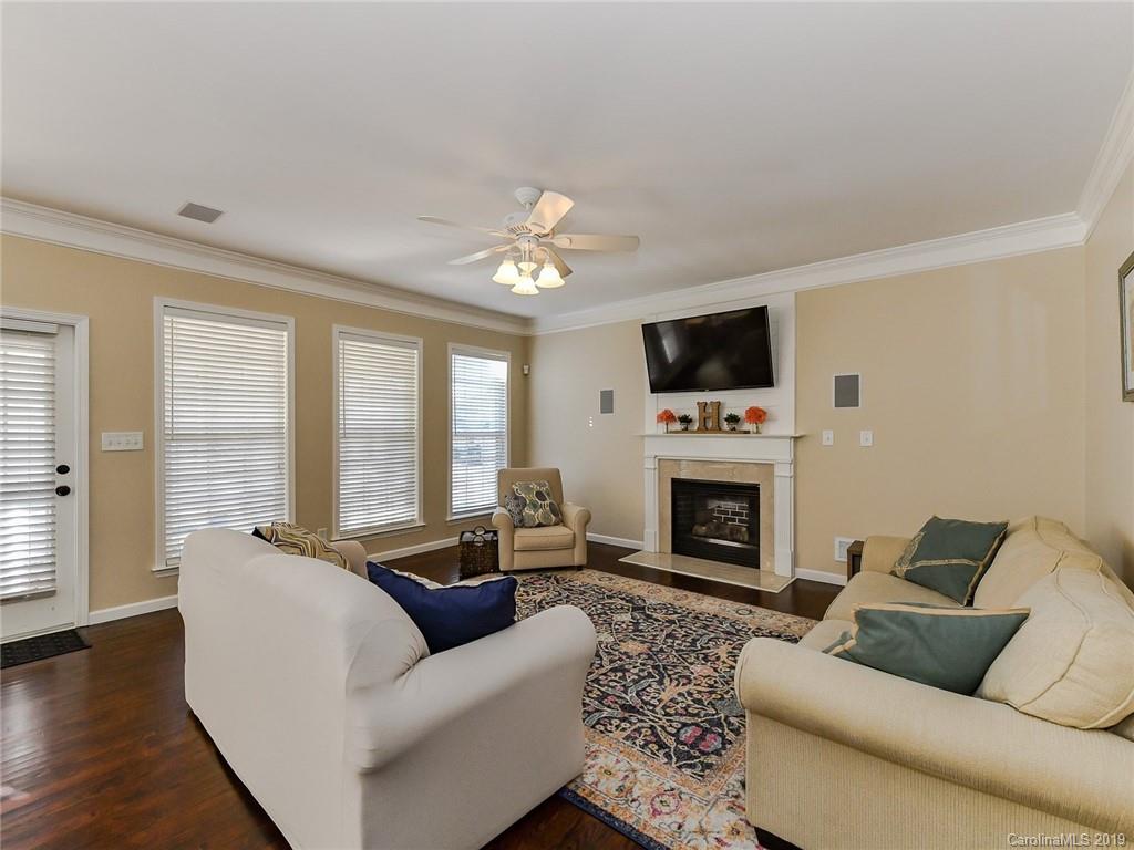 4723 Lapis Court Fort Mill, SC 29708 - Photo 16 of 36 a living room with furniture a fireplace and a flat screen tv