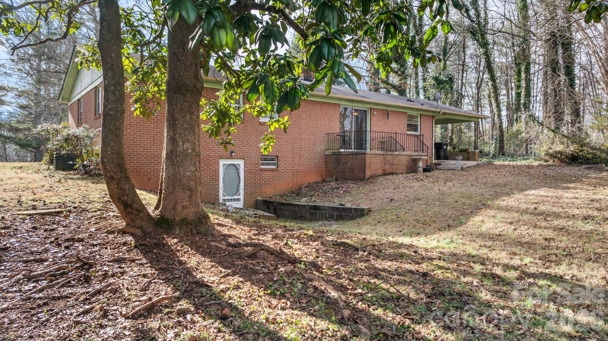 1200 Piedmont Road Morganton, NC 28655 - Photo 23 of 27 a view of a house with a tree in the background