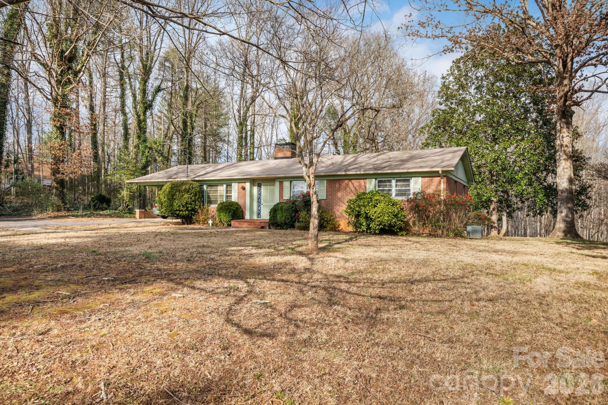 1200 Piedmont Road Morganton, NC 28655 - Photo 24 of 27 a view of a house with a yard and potted plants