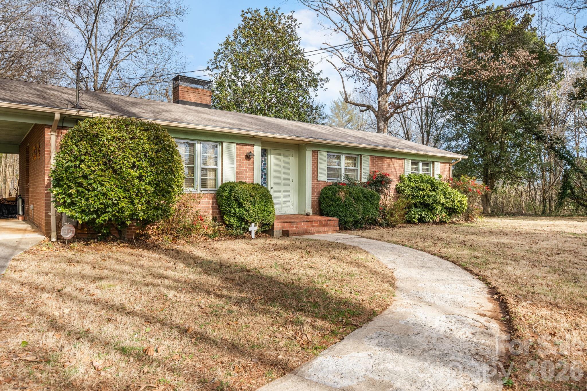 1200 Piedmont Road Morganton, NC 28655 - Photo 25 of 27 a front view of a house with garden