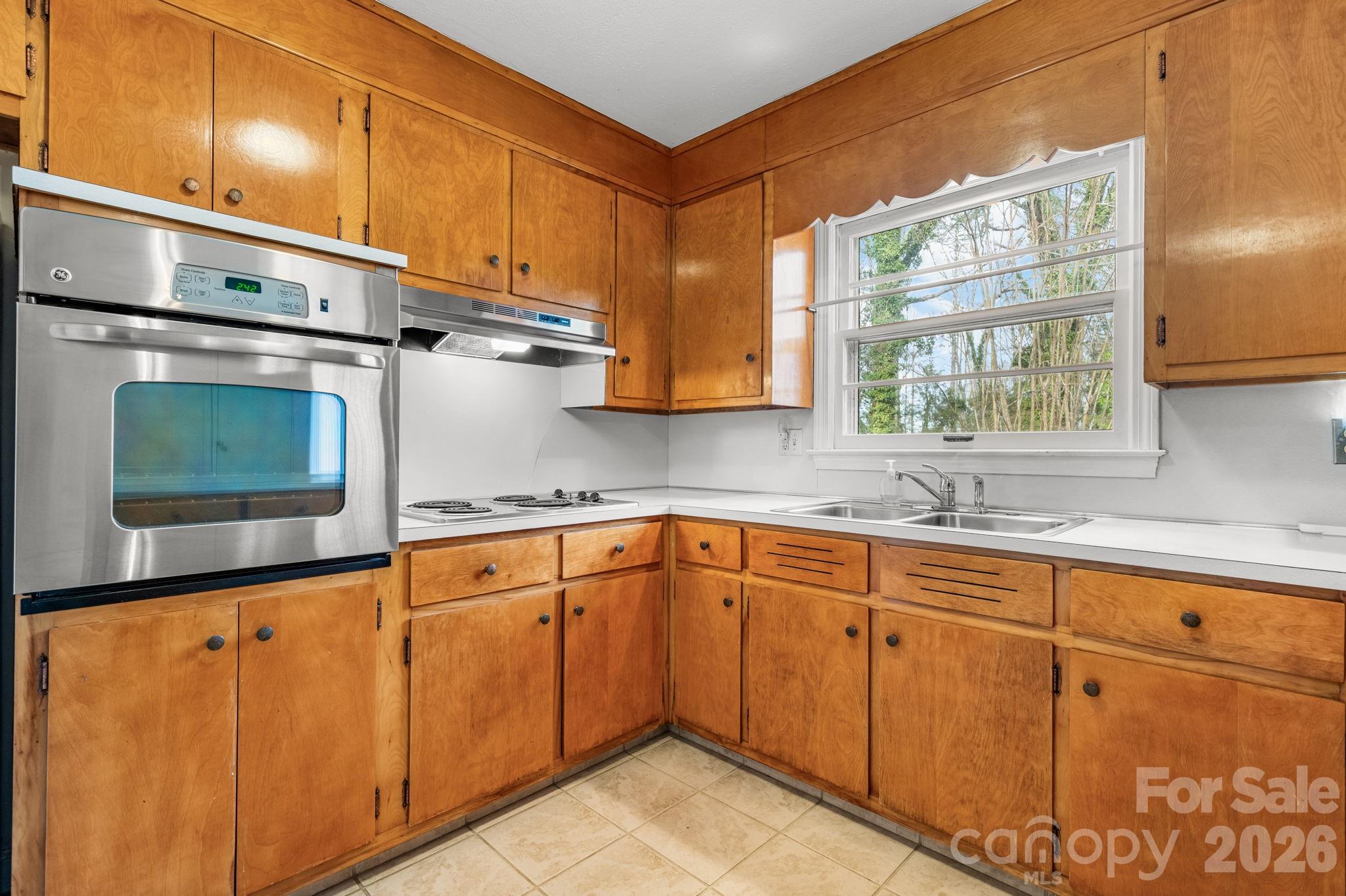 1200 Piedmont Road Morganton, NC 28655 - Photo 4 of 27 a kitchen with granite countertop cabinets stainless steel appliances and a sink