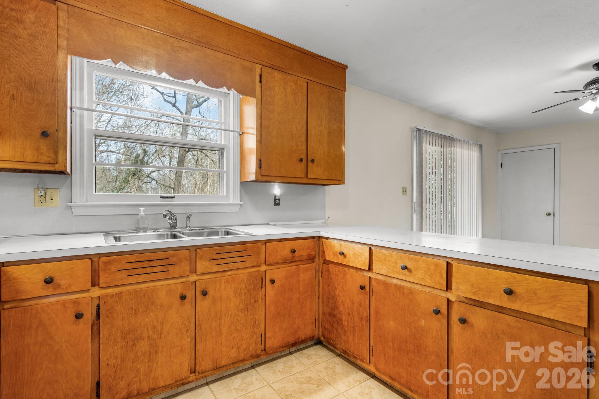 1200 Piedmont Road Morganton, NC 28655 - Photo 5 of 27 a kitchen with granite countertop white cabinets and sink