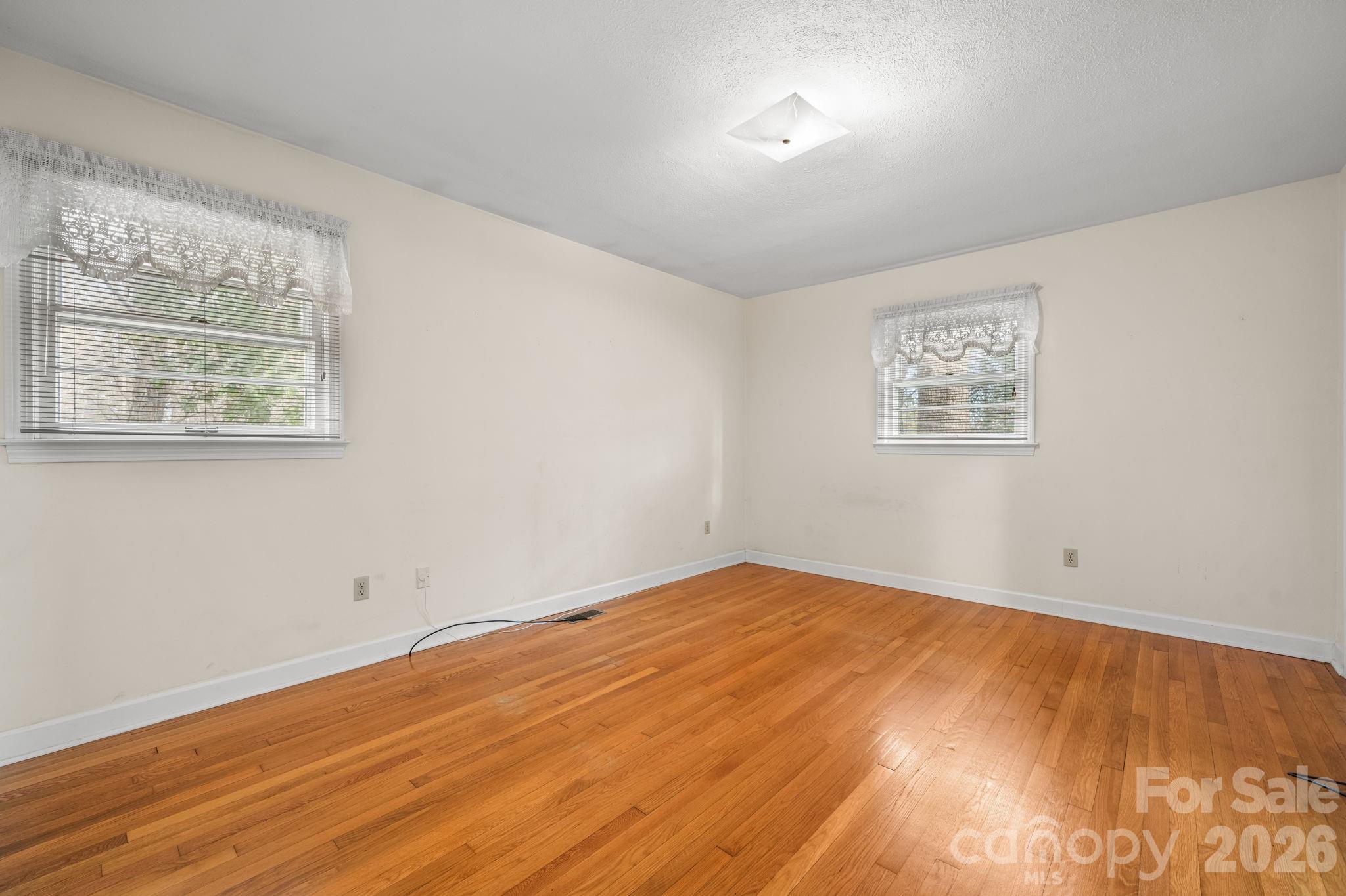 1200 Piedmont Road Morganton, NC 28655 - Photo 8 of 27 a view of empty room with wooden floor and fan