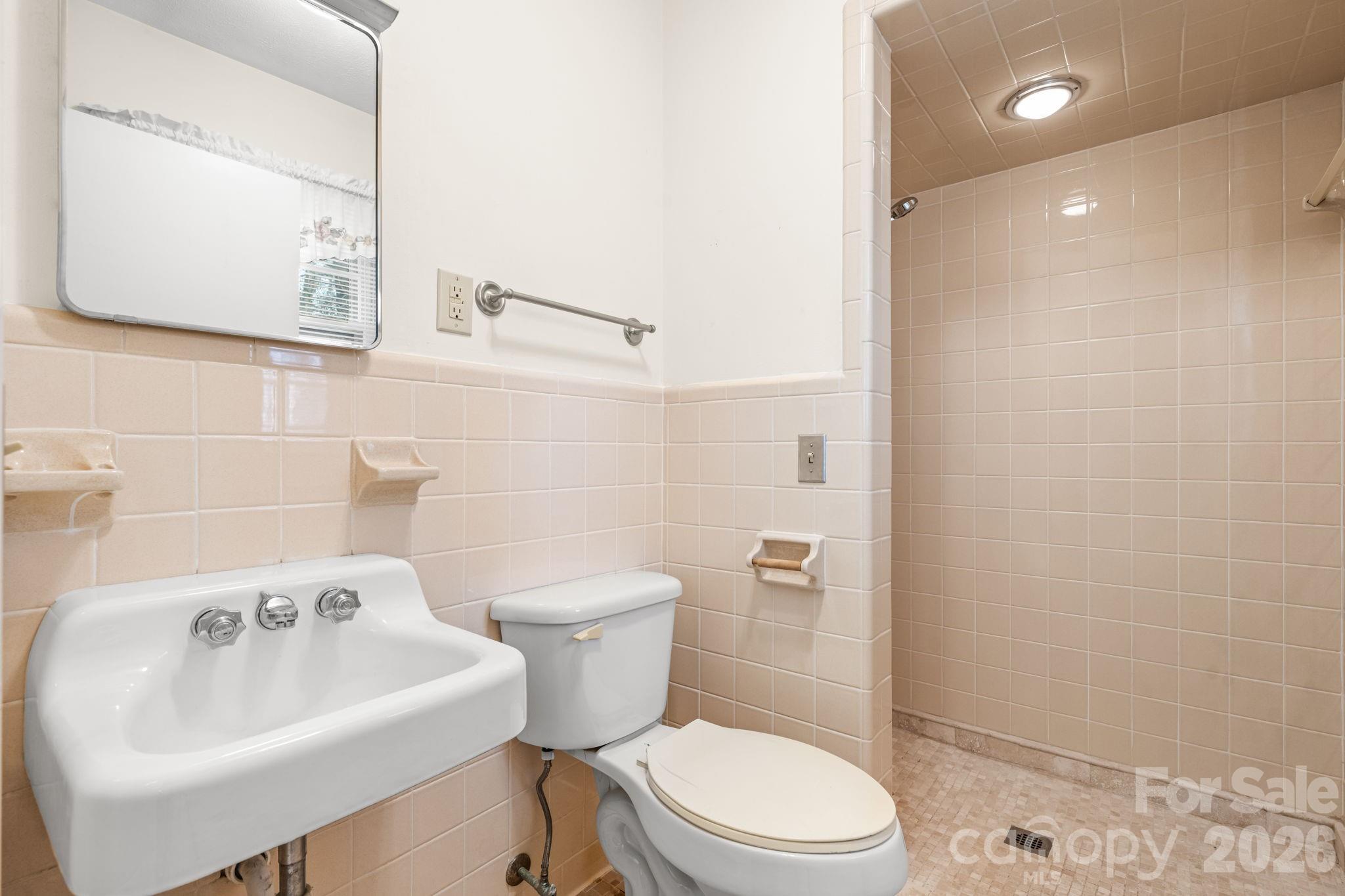 1200 Piedmont Road Morganton, NC 28655 - Photo 10 of 27 a white toilet sitting next to a bathroom sink