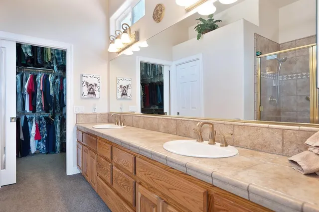 a view of walk in closet with clothes