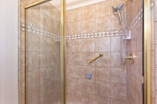a bathroom with a granite countertop sink mirror vanity and toilet