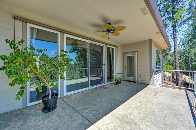 an aerial view of a house with a big yard and large trees